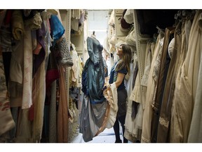 Christine Reimer looks over one of thousands of unique dresses in the giant storage closets in the basement of BMO Theatre.