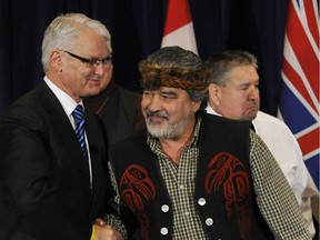 Then-Premier Gordon Campbell shakes hands with Guujaaw, who was president of the Haida Nation, after signing the Haida Protocol that created new economic opportunities on Haida Gwaii.