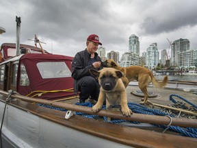 VANCOUVER, BC - MAY 1, 2017 - Shawn Wilson, along with his dogs Sage and her 1 month old puppy Kuma, live on his boat in False Creek in Vancouver, B.C., May 1, 2017.  (Arlen Redekop / PNG staff photo) (story by Dan Fumano) [PNG Merlin Archive]