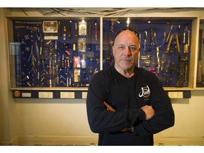 Retired poilceman Al Arsenault in front of "Arsenault's Arsenal," a collection of weapons the Vancouver police have seized off the streets.