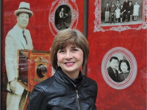 Catherine Clement standing in front of the Yucho Chow "window" that has been installed at 50 East Pender St. in Vancouver. Chow was one of Chinatown's most prolific photographers.