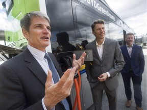 Translink CEO Kevin Desmond (left), Vancouver Mayor Gregor Robertson and BYD Canada vice-president Ted Dowling Friday show off a zero-emission electric bus in 2017.