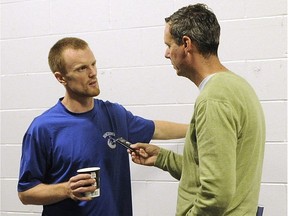 Vancouver Canucks' captain Henrik Sedin talks to columnist Iain Macintyre during the Canucks' 2011-12 training camp at Rogers Arena. MacIntyre is leaving the Vancouver Sun after 27 years in the sports department.