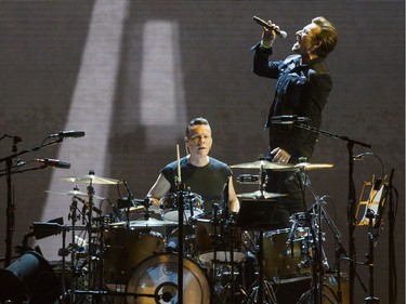 Lead singer Bono sings his heart out as drummer Larry Mullen keeps the beat.