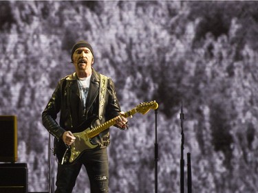 The Edge on stage.