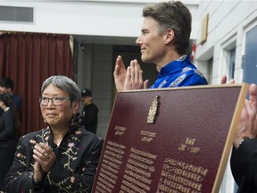 Imogene Lim and Mayor Gregor Robertson help unveil a plaque honouring Nellie Yip Quong as a person of the national historic significance in Vancouver's Chinatown, on May 13.