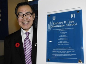Dr. Robert H. Lee poses in 2006 beside a plaque showing that the graduate school at the University of B.C. Sauder School of Business has been named after the former member of the UBC board of governors.