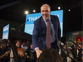 BC NDP Leader John Horgan shakes hands with the crowd at NDP Headquarters in Vancouver, BC, May, 10, 2017.