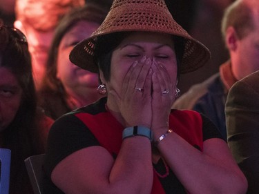 A NDP supporter reacts  as election results are displayed on a screen at BC NDP headquarters in Vancouver on election night.
