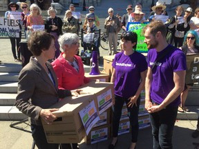 Leadnow members delivered boxes of petitions to Victoria-Beacon Hill MLA Carole James of the NDP, left, and Cowichan Valley MLA-elect Sonia Furstenau of the Greens, on Tuesday May 23, 2017.