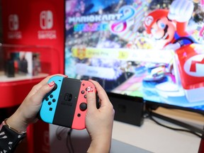 Nintendo of America, A guest enjoys playing Mario Kart 8 Deluxe on the groundbreaking new Nintendo Switch at a special preview event in New York on Jan. 13, 2017.