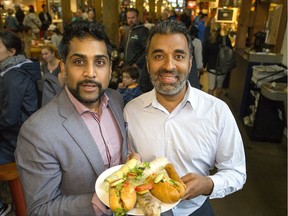 Max Ali (left) and Ravi Singh, directors of the Mela Festival, pose with food from Ong Ba Vietnamese Eatery, a vendor for this year's July 1 festival.