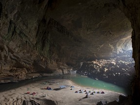 An expedition team sets a base camp inside the mouth of Hang Én.