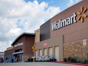 FILE - In an Aug. 26, 2016 file photo, people walk in and out of a Walmart store, in Dallas. Walmart is testing a delivery service using its own store employees, who will deliver packages ordered online while driving home from their regular work shifts. The world&#039;s largest retailer says workers can choose to participate and would be paid. The service is being tested at two stores in New Jersey and one in Arkansas. (AP Photo/Tony Gutierrez, File)