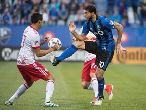 Montreal Impact midfielder Ignacio Piatti, right, kicks the ball away from New York Red Bulls midfielder Sean Davis during first half MLS action Saturday, June 3, 2017 in Montreal. THE CANADIAN PRESS/Paul Chiasson