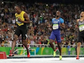 FILE - In this Thursday, Aug. 18, 2016 file photo, Usain Bolt from Jamaica, left, crosses the line to win the gold medal in the men&#039;s 200-meter final ahead of second placed Canada&#039;s Andre De Grasse, right, during the athletics competitions of the 2016 Summer Olympics at the Olympic stadium in Rio de Janeiro, Brazil. Andre De Grasse isn&#039;t interested in considering the expectation that he&#039;ll take over the reins from Usain Bolt as the world&#039;s best sprinter when the eight-time Olympic champion retir