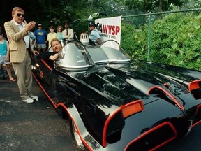 FILE - In this June 27, 1989 file photo, Adam West, left, stands beside the old Batmobile driven by owner Scott Chinery in Philadelphia. On Saturday, June 10, 2017, his family said the actor, who portrayed Batman in a 1960s TV series, has died at age 88. (AP Photo/Cristy Rickard, File)