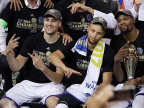 Golden State Warriors guard Klay Thompson, from left, guard Stephen Curry and forward Kevin Durant celebrate after Game 5 of basketball&#039;s NBA Finals against the Cleveland Cavaliers in Oakland, Calif., Monday, June 12, 2017. The Warriors won 129-120 to win the NBA championship. (AP Photo/Marcio Jose Sanchez)