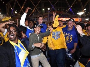 Fans react at Oracle Arena after the Golden State Warriors defeated the Cleveland Cavaliers in Game 5 of basketball&#039;s NBA Finals in Oakland, Calif., Monday, June 12, 2017. The Warriors won 129-120 to win the NBA championship. (AP Photo/Josh Edelson)