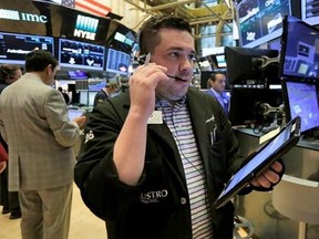 Trader Joseph Lawler works on the floor of the New York Stock Exchange, Friday, June 16, 2017. Major U.S. indexes are slightly lower in early trading on Wall Street, but grocery stores and other retailers are plunging after Amazon said it would buy Whole Foods Market. (AP Photo/Richard Drew)