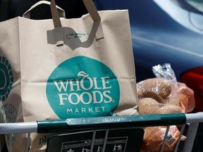 A Whole Foods Market purchase awaits placement in a car trunk, outside the Jackson, Miss., store Friday, June 16, 2017. Amazon is buying Whole Foods in a stunning move that gives it hundreds of stores across the U.S., a brand-new laboratory for radical retail experiments that could revolutionize the way people buy groceries. (AP Photo/Rogelio V. Solis)