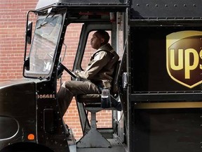In this Tuesday, May 9, 2017, photo, a UPS driver takes his truck on a delivery route, in New York. UPS is adding a new charge of under $1 for shipments to residential customers during peak delivery periods in November and December. On Monday, June 19, 2017, United Parcel Service Inc. said it will add 27 cents for residential deliveries from Nov. 19 to Dec. 2 and Dec. 17-23. UPS will add a fee of between 81 cents and 97 cents to overnight, second- or third-day deliveries for residential deliveri