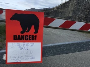 A sign warns people that the trail head is closed on Monday, June 19, 2017, after a fatal bear mauling at Bird Ridge Trail in Anchorage, Alaska. Authorities say a black bear killed a 16-year-old runner while he was competing in an Alaska race on Sunday. (AP Photo/Mark Thiessen)