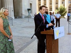 Missouri Attorney General Josh Hawley speaks at a news conference Wednesday, June 21, 2017, in St. Louis where announced he is suing three large pharmaceutical companies, saying their deceptive marketing practices contributed to an opioid abuse crisis in the state. Looking on at left is Jammie Fabick, whose 17-year-old daughter died of an opioid overdose in 2014. (AP Photo/Jim Salter)
