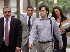 FILE - In this Monday, June 19, 2017, file photo, former Turing Pharmaceuticals CEO Martin Shkreli, second from right, arrives at Brooklyn federal court with members of his legal team, in New York, for a pretrial conference in his securities fraud trial. Shkreli&#039;s trial begins Monday, June 26, 2017. (AP Photo/Mark Lennihan, File)