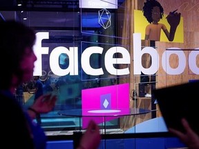 FILE - In this Tuesday, April 18, 2017, file photo, conference workers speak in front of a demo booth at Facebook&#039;s annual F8 developer conference, in San Jose, Calif. Facebook announced Tuesday, June 27, 2017, that it now has more than 2 billion users. (AP Photo/Noah Berger, File)