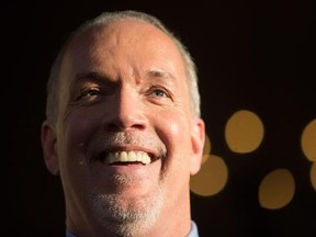 British Columbia Premier-designate, NDP Leader John Horgan smiles while speaking outside Government House after meeting with Lt-Gov. Judith Guichon in Victoria, B.C., on Thursday, June 29, 2017. Horgan&#039;s fight for society&#039;s underdogs started early in life. His father died from a brain aneurysm when he was 18 months old. Money was tight for his mother who struggled to raise four children alone and there were times food hampers were delivered to the Horgan home. THE CANADIAN PRESS/Darryl Dyck
