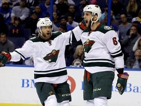 FILE - In this April 24, 2015, file photo, Minnesota Wild&#039;s Jason Pominville, left, congratulates teammate Marco Scandella after he scored during the first period in Game 5 of an NHL hockey first-round playoff series against the St. Louis Blues, in St. Louis. Former Sabres captain Jason Pominville is returning to Buffalo after being acquired along with defenseman Marco Scandella in a four-player trade with the Minnesota Wild, Friday, June 30, 2017. (AP Photo/Jeff Roberson, File)
