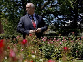 B.C. NDP leader John Horgan buttons up his jacket after speaking to media from the Rose Garden at B.C. Legislature in Victoria, B.C., on Monday, June 26, 2017.