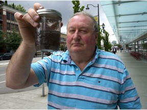 White Rock resident Garry Wolgemuth holds a jar Wednesday containing water he said came from his kitchen tap.