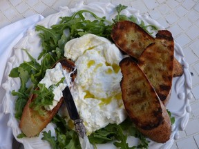 Burrata, drizzled with olive oil and served with grilled bread, for a Canadian celebration cookout.