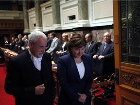 B.C. Liberal MLA Christy Clark talks with Sergeant at Arms Gary Lenz as she waits before officially being sworn-in as a member of the legislative assembly during a ceremony at Legislature in Victoria, B.C., on Thursday, June 8, 2017.