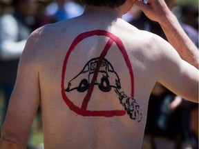 A cyclist sports an anti-car logo while participating in the World Naked Bike Ride event in Vancouver, B.C., on Saturday June 13, 2015.