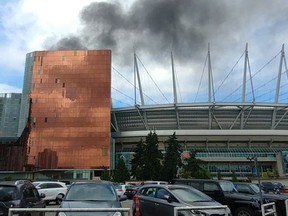 Smoke billows from behind the Parq Vancouver casino and resort.