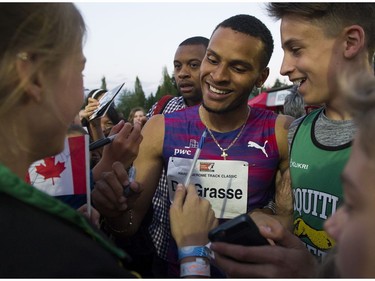 Andre De Grasse is mobbed after running  the men's 100m event at the 2017 Vancouver Sun Harry Jerome Track Classic at the Percy Perry stadium, Coquitlam, June 28 2017.