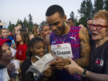 Andre De Grasse signs autographs after running  the men's 100m event at the 2017 Vancouver Sun Harry Jerome Track Classic at the Percy Perry stadium, Coquitlam, June 28 2017.