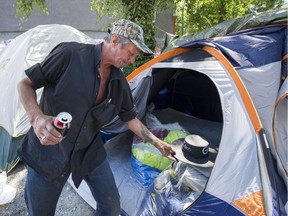 Dennis DeGuerre prepares to pack up his tent and belongings.