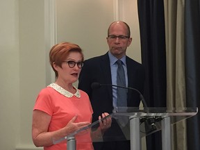 Joy MacPhail and Allan Seckel, vice-chair and chair of the independent mobility pricing commission, address media in June.