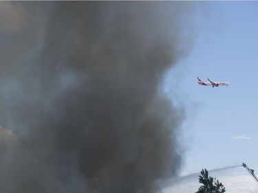 RICHMOND. June 16 2017. A plane flies past firefighters fighting a fire burning on Mitchell island, Richmond, June 16 2017.  Gerry Kahrmann  /  PNG staff photo) ( Prov / Sun News ) 00049630A   [PNG Merlin Archive]
Gerry Kahrmann, PNG