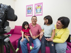 Lino Coria and his wife Marcela de la Pena record a video with their two daughters Julia Coria de la Pena and Emilia Coria de la Pena, in their Port Moody home last week. Coria is known to thousands of his YouTube fans in his native Mexico for telling stories about the lives of his young family in Canada.