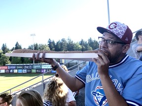 Vancouver Canadians fan Juan Ramos ate his height - six-foot-four - in hotdogs on opening day at Nat Bailey Stadium.