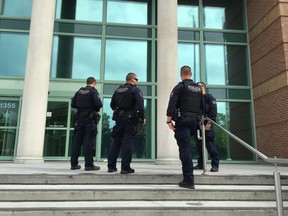 Gang police on steps of the Kelowna Law Courts on June 1, 2017.