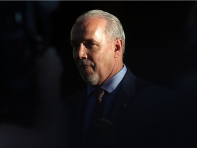 NDP leader and Premier-designate John Horgan makes a brief statement and answers questions from the media after meeting with Lt.-Gov. Judith Guichon at the Government House in Victoria on Thursday.