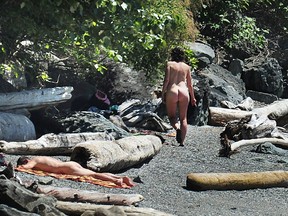 Nude sunbathers at Brunswick Beach in Lions Bay. The beach, which has had a quiet clothing-optional component for many years, was recently overwhelmed with visitors — and their cars.