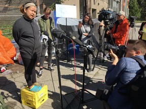 A tent-city resident addresses the media Friday a day after they were served a trespass order demanding they leave the Main Street site in Vancouver.