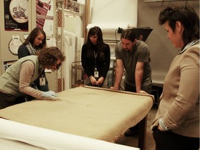 Burke Museum researchers study a Coast Salish blanket that was recently found to contain hair from an extinct woolly dog.